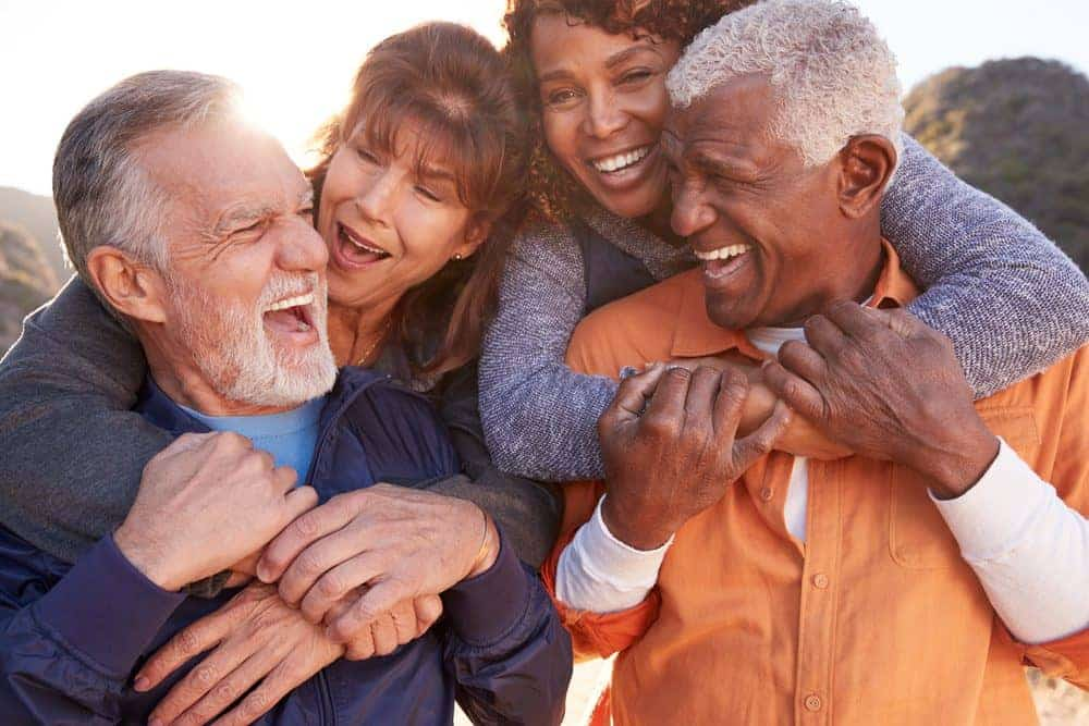 Smiling,Senior,Friends,Having,Fun,Walking,In,Countryside,Together