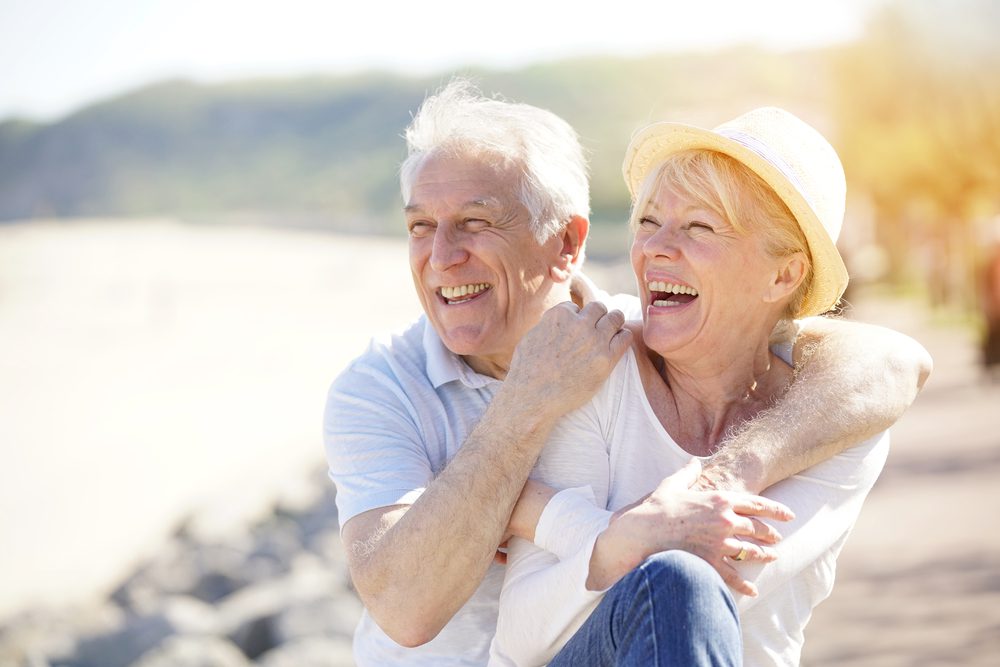 Senior,Couple,Relaxing,By,The,Sea,On,Sunny,Day