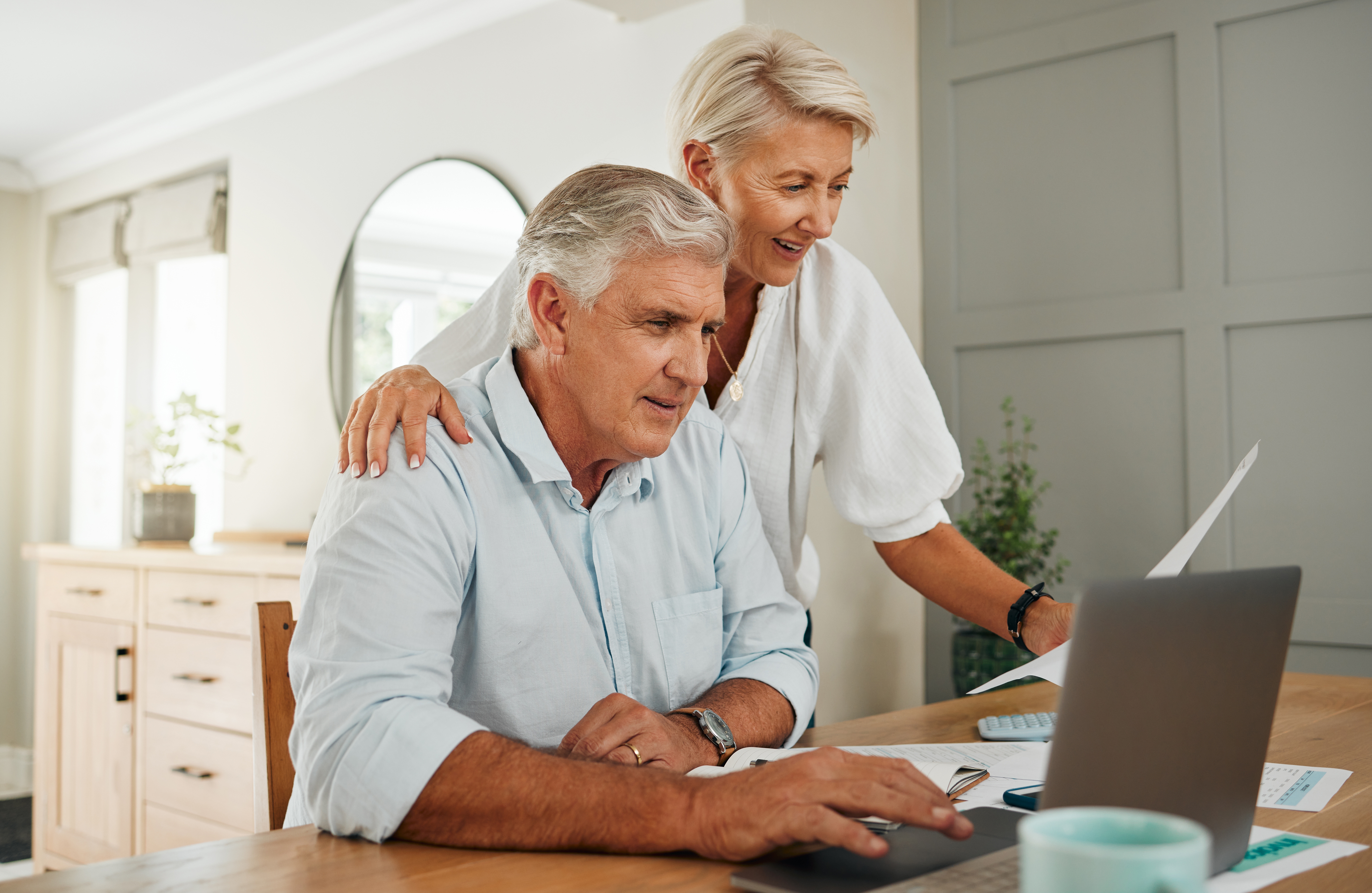 Senior,Couple,With,Laptop,For,Life,Insurance,Documents,,Home,Retirement