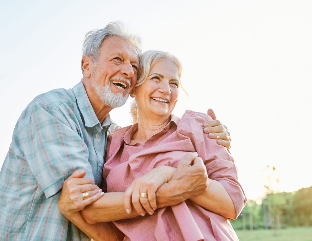 Happy,Active,Senior,Couple,Having,Fun,Talking,And,Hugging,In